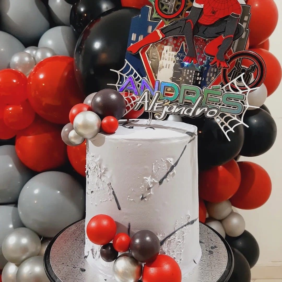 Close-up of the red, black and silver Spider-Man themed cake and balloon display
