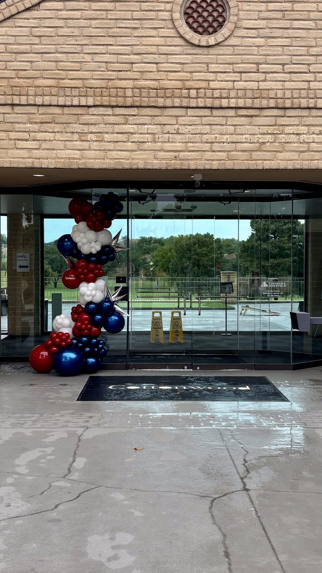 Interior view of the navy, red and white balloon garland framing the glass entrance door