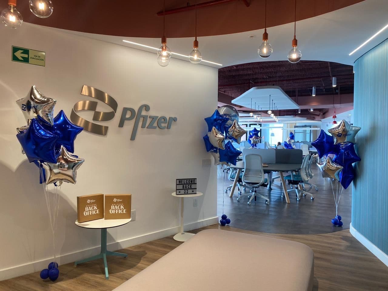 Blue and silver star balloon bouquets decorating an office lobby for a corporate event