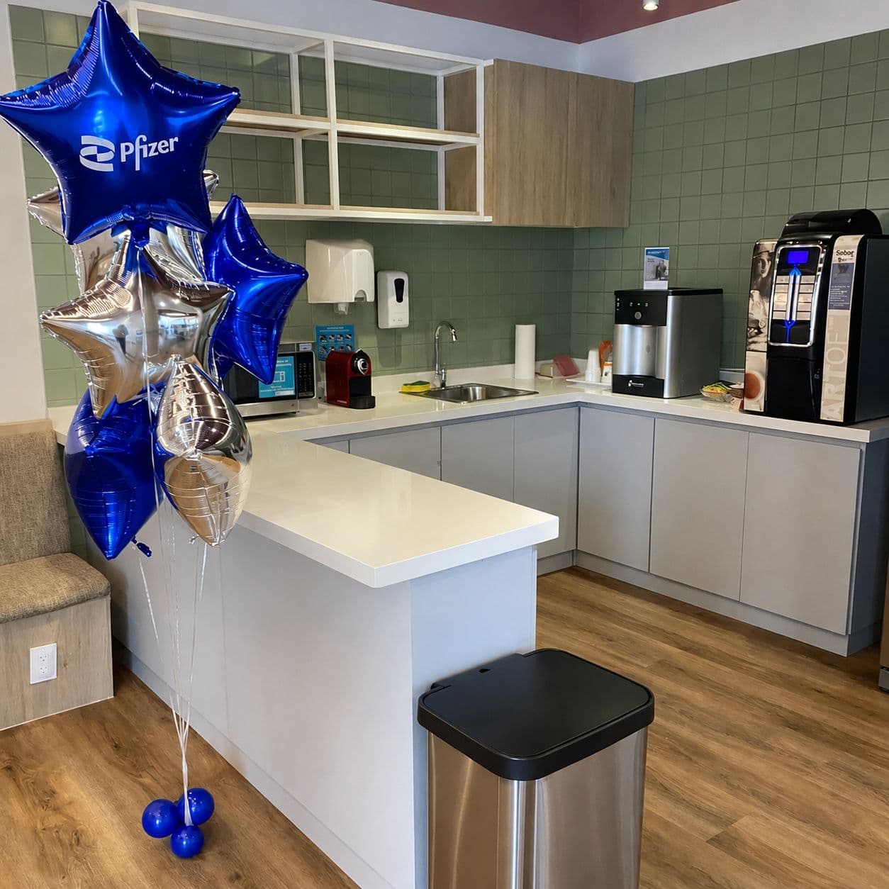 Blue and silver star balloon bouquet in an office break room for a corporate welcome event