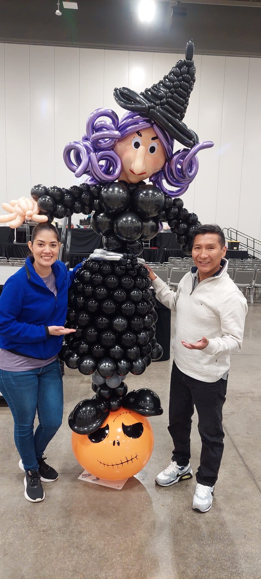 Purple and green Hulk balloon sculpture at an event